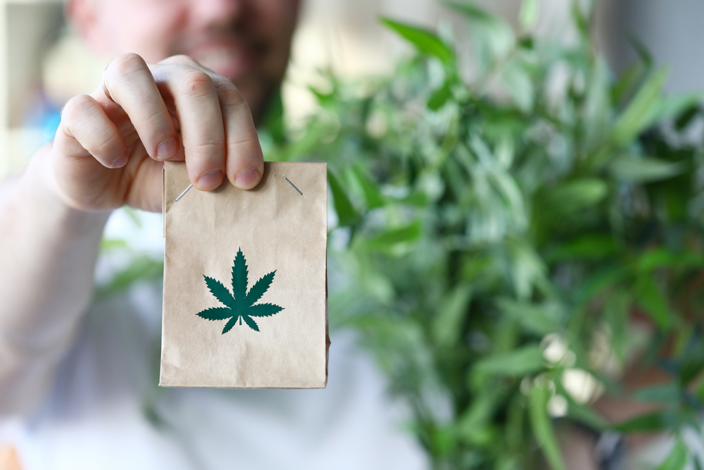 woman holding a bag of marijuana that was purchased at a dispensary