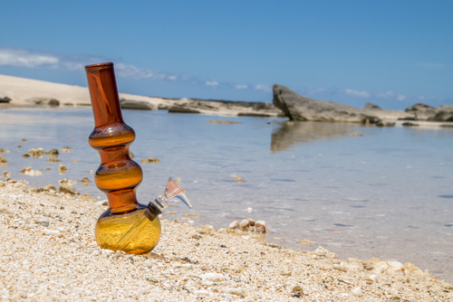 pipe for smoking marijuana on the beach in the summer using new strains from rol